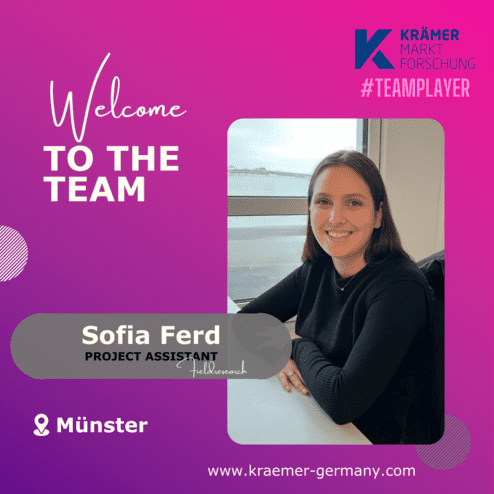 Frau sitzt an einem Tisch mit Fensterblick, präsentiert als neue Projektassistentin in einem binären Design.